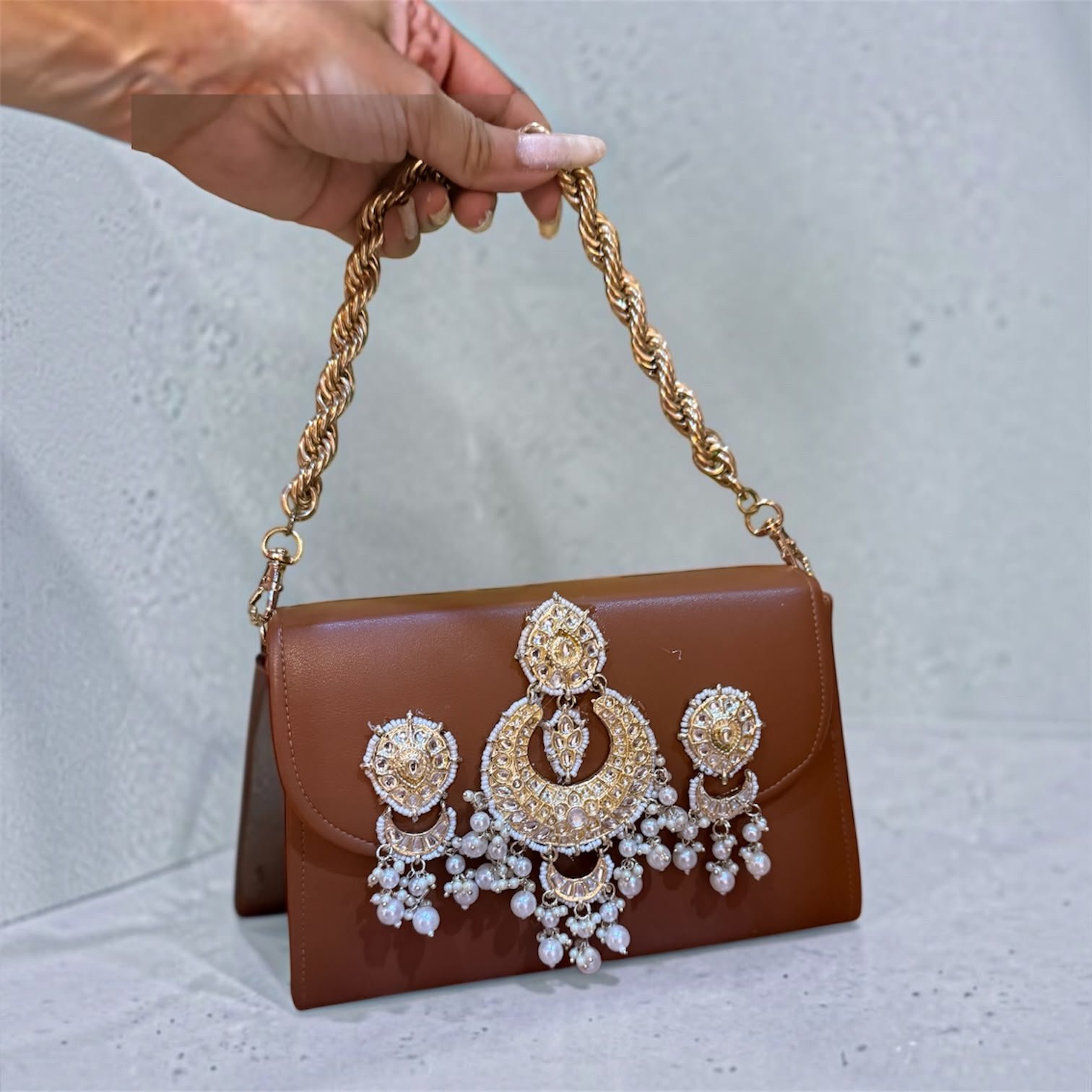 Embellished statement sling bag